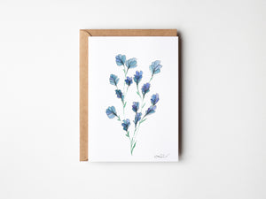 Eco-friendly watercolour print of soft, delicate blue flowers with fine brushstrokes and a calming, airy composition.