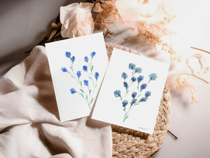 Eco-friendly watercolour print of soft, delicate blue flowers with fine brushstrokes and a calming, airy composition.
