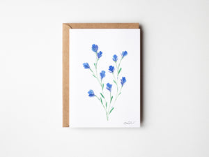 Eco-friendly watercolour print of loosely painted tiny blue wildflowers, scattered with a light, whimsical touch.