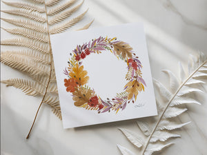 Watercolour greeting card featuring a beautiful autumn wreath with rich oranges, deep reds, and earthy greens. The design evokes the cozy charm and beauty of the fall season, bringing warmth and elegance to any space.
