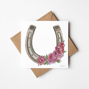 Pink Fortune watercolor greeting card featuring a horseshoe surrounded by pink crepe myrtle blossoms, nature-inspired art on sustainable paper