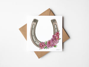 Pink Fortune watercolor greeting card featuring a horseshoe surrounded by pink crepe myrtle blossoms, nature-inspired art on sustainable paper