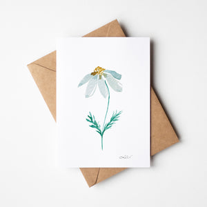 Dizzy Daisy Greeting Card – Eco-friendly greeting card featuring a delicate watercolor illustration of a single daisy with soft, organic petals.