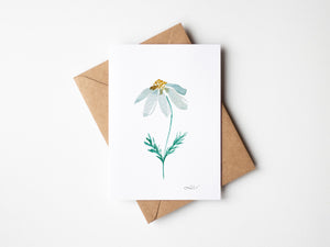 Dizzy Daisy Greeting Card – Eco-friendly greeting card featuring a delicate watercolor illustration of a single daisy with soft, organic petals.