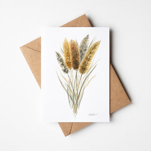 Watercolour greeting card featuring golden cattails with tall, slender reeds and soft brown flower spikes. The design captures the serene and rustic beauty of wetlands and marshes.