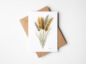 Watercolour greeting card featuring golden cattails with tall, slender reeds and soft brown flower spikes. The design captures the serene and rustic beauty of wetlands and marshes.