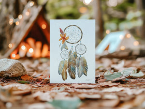 Watercolour greeting card featuring a dreamcatcher with vibrant orange and crimson feathers. The design symbolizes healing, reconciliation, and remembrance, reflecting the connection between tradition and the earth.