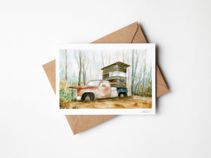 Watercolour greeting card featuring an old truck, Ol' Rusty, converted into a deer stand in a misty field. The design reflects the passage of time as nature reclaims the weathered truck, blending tradition and the beauty of the wild.