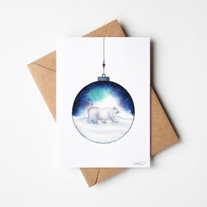Aurora Polar Bear Greeting Card – Eco-friendly greeting card featuring a delicate watercolour illustration of a polar bear inside an ornamental ball, with the Aurora Borealis in the background.