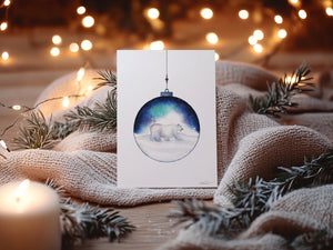 Aurora Polar Bear Greeting Card – Eco-friendly greeting card featuring a delicate watercolour illustration of a polar bear inside an ornamental ball, with the Aurora Borealis in the background.