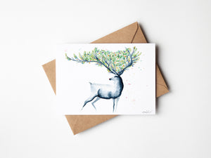 Christmas Reindeer Greeting Card – Eco-friendly greeting card featuring a hand-painted watercolour illustration of a reindeer in a wintry landscape, capturing the festive spirit.