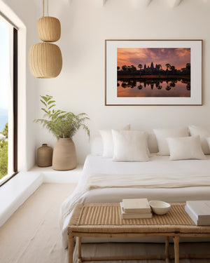 Fine art landscape photograph of Angkor Wat at dawn, with a soft veil of colour, tranquil reflection, and atmospheric light surrounding the temple silhouette.