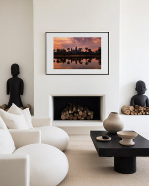 Fine art landscape photograph of Angkor Wat at dawn, with a soft veil of colour, tranquil reflection, and atmospheric light surrounding the temple silhouette.