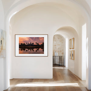 Fine art landscape photograph of Angkor Wat at dawn, with a soft veil of colour, tranquil reflection, and atmospheric light surrounding the temple silhouette.