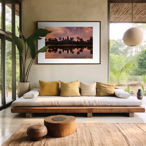 Fine art landscape photograph of Angkor Wat at dawn, with a soft veil of colour, tranquil reflection, and atmospheric light surrounding the temple silhouette.