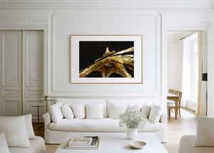 Fine art photograph of the Eiffel Tower at night, glowing against the Parisian sky in a romantic, luminous scene.