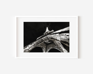 Fine art photograph of the Eiffel Tower at night, glowing against the Parisian sky in a romantic, luminous scene.