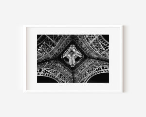 Fine art photograph of the Eiffel Tower at night, highlighting the star-shaped pattern of lights beneath its structure.