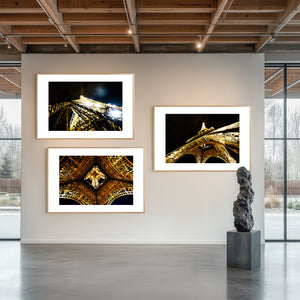 Fine art photograph of the Eiffel Tower at night, showing sparkling, bursting lights against the Parisian sky.
