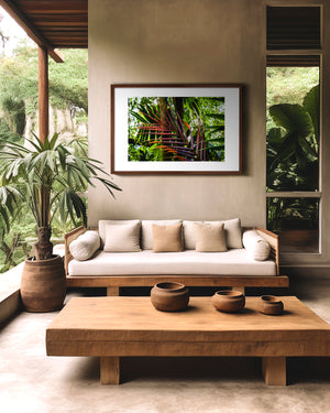 Fine art photograph of a palm branch in warm ember tones set against a green rainforest, highlighting colour contrast, texture, and tropical natural beauty.