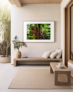 Fine art photograph of a palm branch in warm ember tones set against a green rainforest, highlighting colour contrast, texture, and tropical natural beauty.