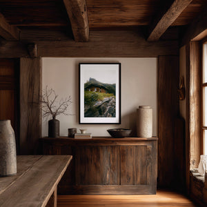 Dreamy hidden wooden cabin beneath a mountain in Norway, moody fine art landscape photography print.
