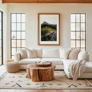 Dreamy hidden wooden cabin beneath a mountain in Norway, moody fine art landscape photography print.