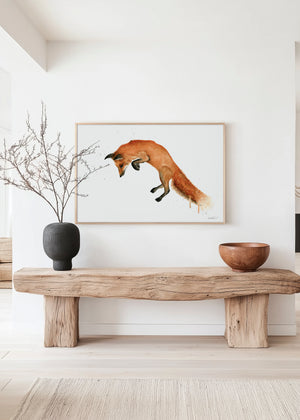 A vibrant watercolour painting of a fox mid-leap, capturing its playful energy and graceful movement. The artwork showcases delicate brushstrokes and vivid colours, highlighting the fox’s elegant form against a soft, natural background.