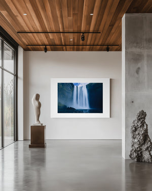 Fine art photograph of Skogafoss waterfall in Iceland, capturing its powerful vertical drop and mist in dramatic natural light.