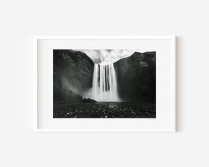Fine art photograph of Skogafoss waterfall in Iceland, showing its vast surrounding landscape and mist-filled atmosphere.