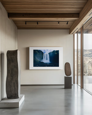 Fine art photograph of Skogafoss waterfall in Iceland, showing its vast surrounding landscape and mist-filled atmosphere.
