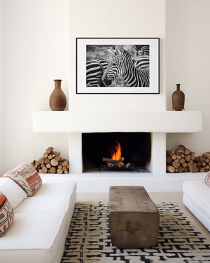 A group of zebras standing closely together, their stripes blending in soft patterns. Fine art wildlife photo taken in Ngorongoro Conservation Area.